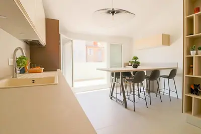 a kitchen with a table and chairs and a sink at MEYNADIER Renovated designer apartment with rooftop in Cannes in Cannes