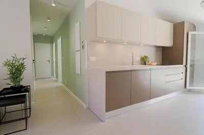 a kitchen with white cabinets and a sink at MEYNADIER Renovated designer apartment with rooftop in Cannes in Cannes