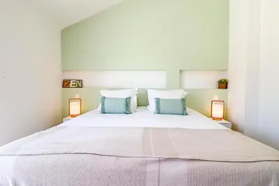 a bedroom with a large bed with two lamps at MEYNADIER Renovated designer apartment with rooftop in Cannes in Cannes
