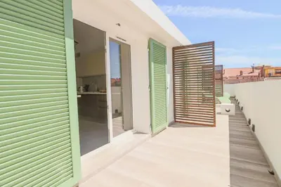 a balcony of a house with green and white shutters at MEYNADIER Renovated designer apartment with rooftop in Cannes in Cannes