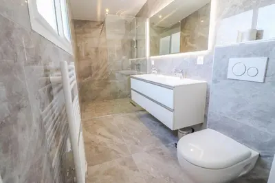 a bathroom with a white toilet and a sink at MEYNADIER Renovated designer apartment with rooftop in Cannes in Cannes