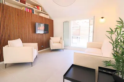 a living room with two chairs and a couch at MEYNADIER Renovated designer apartment with rooftop in Cannes in Cannes