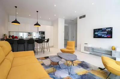 a living room with a couch and a table at NAPOLEON Luxurious renovated apartment 1min from Palais in Cannes