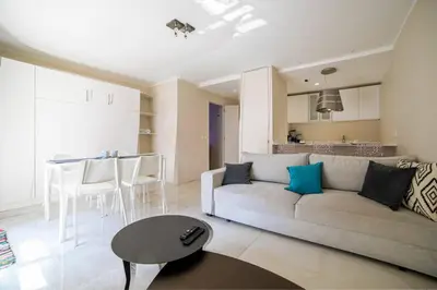 a living room with a couch and a table at Coeur De Cannes in Cannes