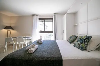 a bedroom with a large bed with towels on it at Coeur De Cannes in Cannes