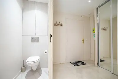 a white bathroom with a toilet and a shower at Coeur De Cannes in Cannes