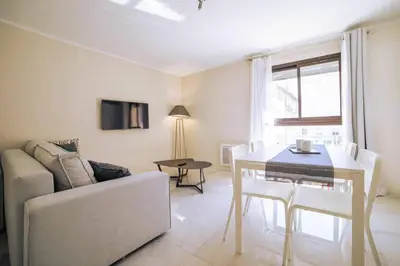 a living room with a couch and a table at Coeur De Cannes in Cannes