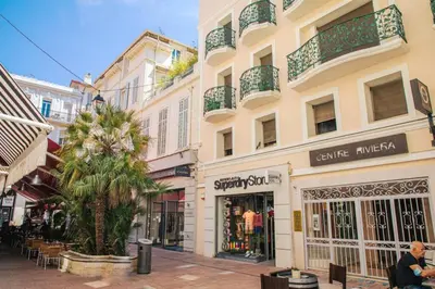 a street in a city with shops and buildings at Coeur De Cannes in Cannes