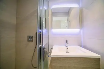 a bathroom with a sink and a mirror and a shower at Coeur De Cannes in Cannes