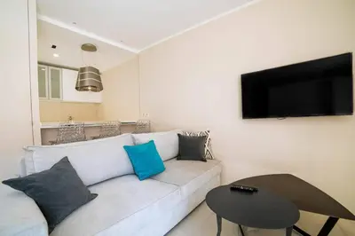 a living room with a white couch and a table at Coeur De Cannes in Cannes