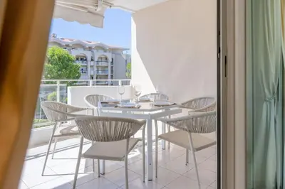 a patio with a table and chairs on a balcony at 3-Room Apartment in Prestigious Residence in Cannes