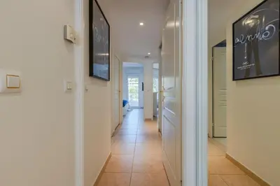 a hallway with white walls and a tile floor at 3-Room Apartment in Prestigious Residence in Cannes