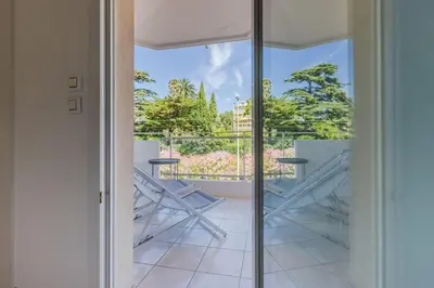 a view from the door of a balcony with chairs at 3-Room Apartment in Prestigious Residence in Cannes
