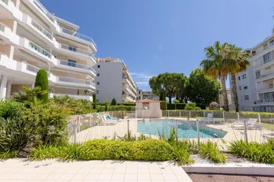 a swimming pool in front of a building at 3-Room Apartment in Prestigious Residence in Cannes
