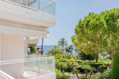 a house with a balcony with a view of the ocean at 3-Room Apartment in Prestigious Residence in Cannes