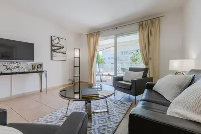 a living room with a couch and a table at 3-Room Apartment in Prestigious Residence in Cannes
