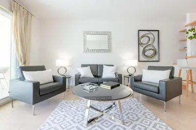 a living room with two chairs and a table at 3-Room Apartment in Prestigious Residence in Cannes