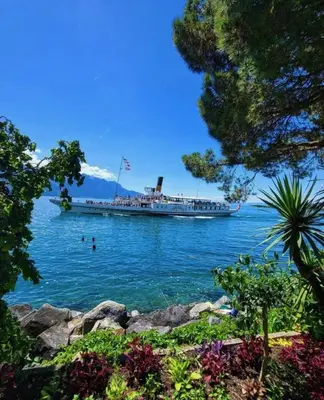 a large boat in the water with people in it at Magnifique appartement Cosy Cannes à 5mn du fameux palais du festival et ses plages in Cannes