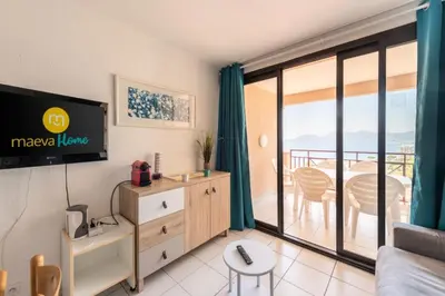 a living room with a tv and a balcony at Résidence Cannes Villa Francia - maeva Home - Appartement 2 pièces 6 personnes - Sélection MAE-2534 in Cannes