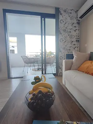 a living room with a bowl of fruit on the floor at Cannes & More in Cannes