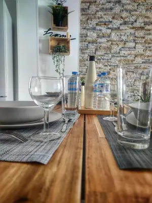 a table with wine glasses on a wooden table at Cannes Holiday suite à 2 pas du festival et plages in Cannes