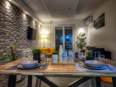a dining room table with bowls and glasses on it at Cannes Holiday suite à 2 pas du festival et plages in Cannes