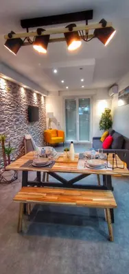 a living room with a table and a couch at Cannes Holiday suite à 2 pas du festival et plages in Cannes