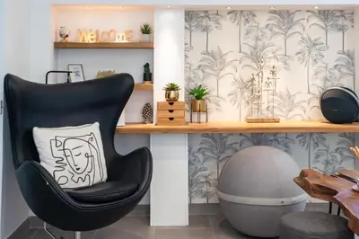 a black chair with a pillow sitting on a shelf at Cozy 2-Br Apartment 1 min from the Beaches in Cannes