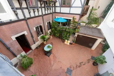 an overhead view of a courtyard with an umbrella at Cozy 2-Br Apartment 1 min from the Beaches in Cannes