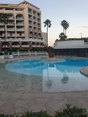 a large swimming pool in front of a hotel at Appartement en bord de mer in Cannes