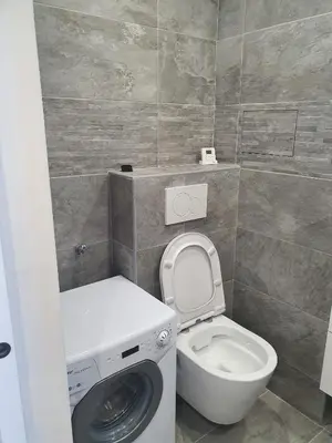 a bathroom with a washing machine and a toilet at Appartement en bord de mer in Cannes