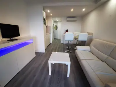 a living room with a couch and a table at Appartement en bord de mer in Cannes