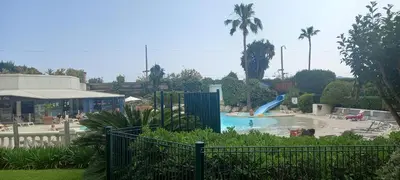 a swimming pool with a slide in a park at Villa Maupassant 06 Cannes in Cannes