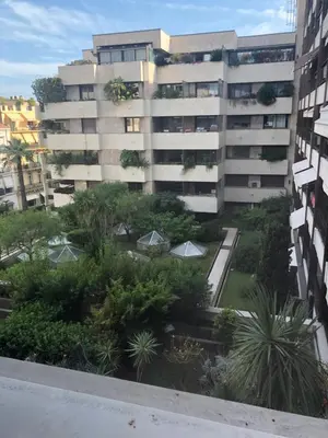 an apartment building with a garden in front of it at Studio Cannes Gray d'Albion in Cannes