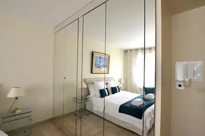 a bedroom with a bed and a glass wall at Studio Cannes Gray d'Albion in Cannes