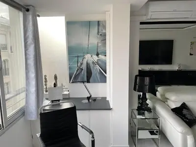 a bedroom with a bed and a desk with a chair at Ibis croisette in Cannes