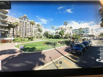 a view of a street with a car parked in a parking lot at Ibis croisette in Cannes