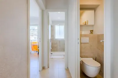 a bathroom with a white toilet and a shower at Stylish 1-Bedroom Apartment Close to Beaches in Cannes