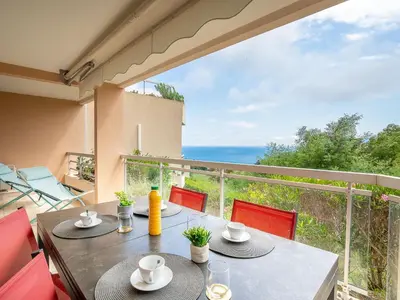 a dining table with a view of the ocean at Apartment La Croix des Gardes by Interhome in Cannes