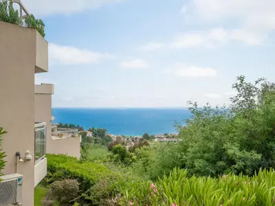 a view of the ocean from a house at Apartment La Croix des Gardes by Interhome in Cannes