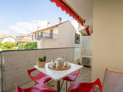 a small white table and chairs on a balcony at Apartment Le Puget by Interhome in Cannes