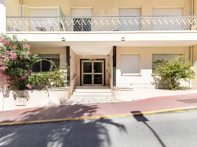 a building with a door and flowers on a street at Apartment Le Puget by Interhome in Cannes