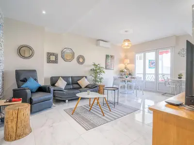 a living room with a couch and a table at Apartment Le Puget by Interhome in Cannes
