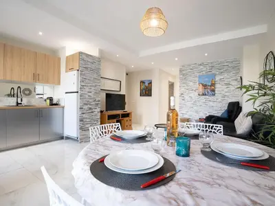 a dining room and kitchen with a table and chairs at Apartment Le Puget by Interhome in Cannes