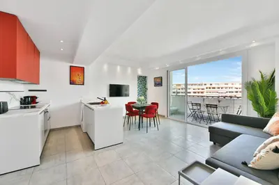 a kitchen and living room with a couch and a table at CROISETTE BEACH - Modern 2 Bdrs Best Location! in Cannes