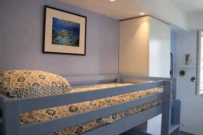 a bunk bed in a room with a picture on the wall at CROISETTE BEACH - Modern 2 Bdrs Best Location! in Cannes