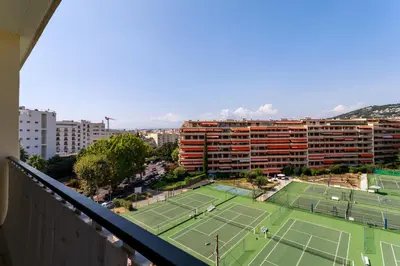 an apartment with two tennis courts in front of a building at CROISETTE BEACH - Modern 2 Bdrs Best Location! in Cannes