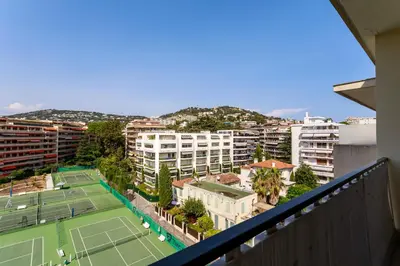 a balcony with a tennis court and buildings at CROISETTE BEACH - Modern 2 Bdrs Best Location! in Cannes