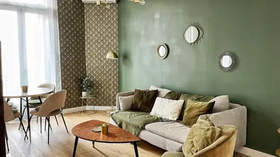 a living room with a couch and a table at Le Cannois by Coeur de Loup in Cannes