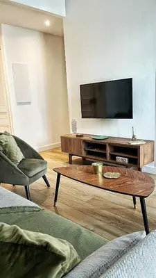 a living room with a couch and a table at Le Cannois by Coeur de Loup in Cannes